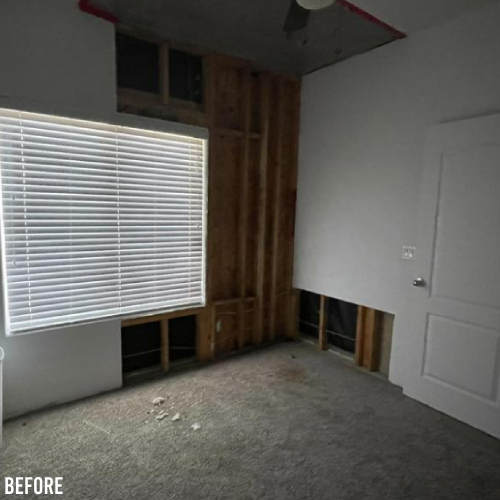 A dimly lit, unfinished room with exposed wooden beams, a carpeted floor, a window with closed blinds, and a white door partially open. "Before" is labeled in the bottom left corner.