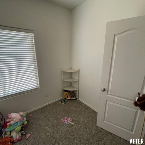 Room with white walls and a door, featuring a window with blinds, a corner shelf with books, and toys scattered on the carpeted floor. "AFTER" is written in the bottom right corner.